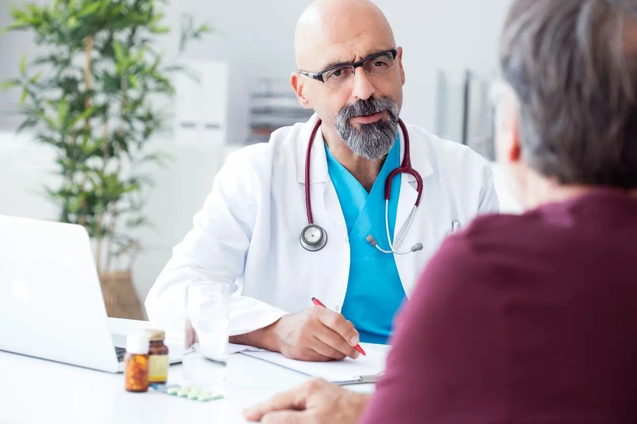 A doctor is talking to someone in the hospital.